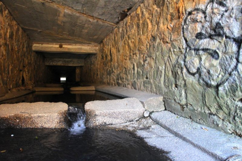 An entire river flows through downtown in a Victorian tunnel