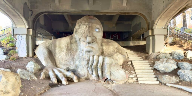 The Fremont Troll crushes a VW Bug under the Aurora Bridge